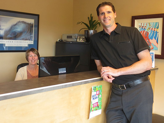 Dr. Janzen and receptionist at Chiropractic clinic in Cochrane.