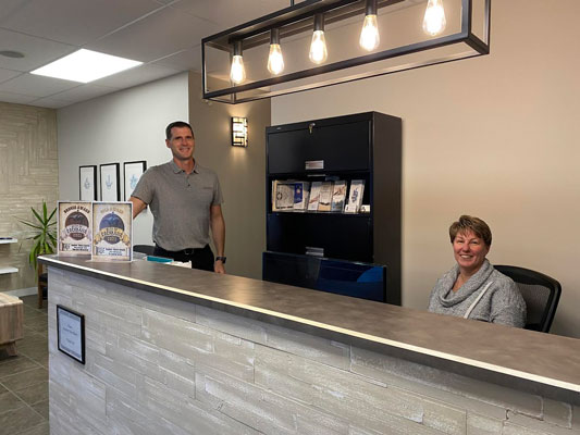 cochrane chiropractic office receptionist with chiropractor, Dr. Janzen